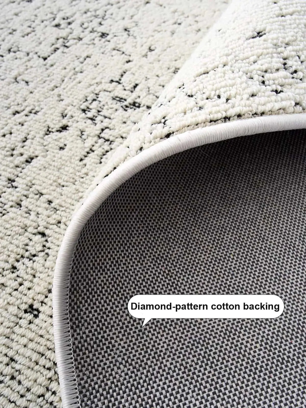 Close-up of area rug with diamond-pattern cotton backing for anti-slip and durability