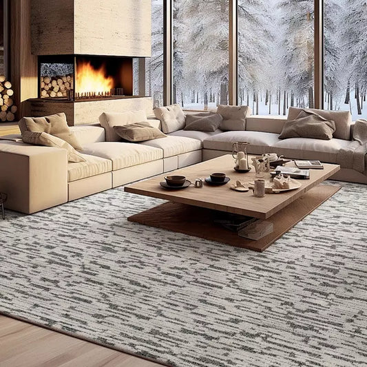 Gray and white textured area rug in a winter living room with a fireplace, wooden furniture, and snowy outdoor view #Texture_Black & White Checks  #Texture_Abstract Lines
