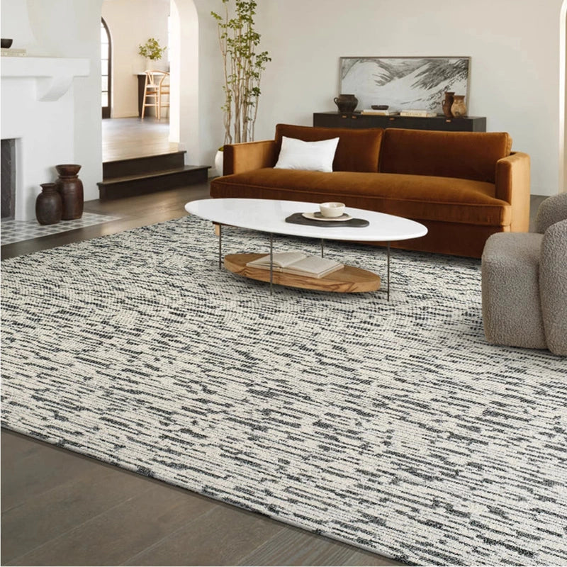 Modern living room with a black-and-white area rug paired with a velvet sofa and oval coffee table #Texture_Abstract Lines