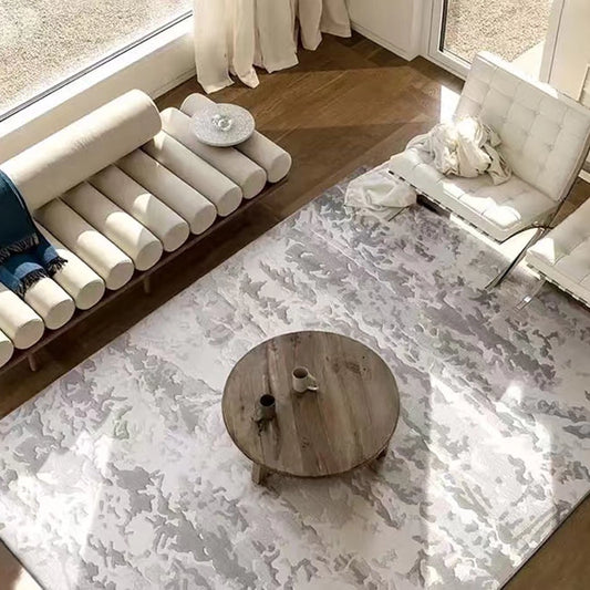 Abstract gray rug in a sunlit living room with a wooden coffee table and modern white seating #Texture_Stormy Texture