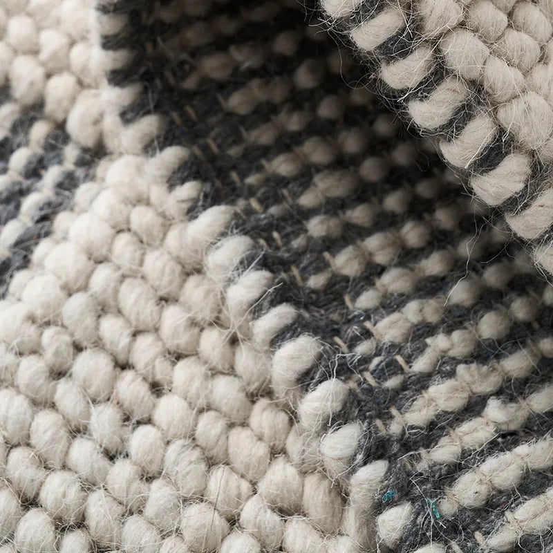 Detailed close-up of the black and white checkered wool rug, highlighting its handwoven texture and natural fibers #color_Black & White Check