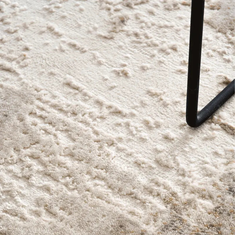 Close-up of a plush texture beige rug with subtle patterns and soft pile