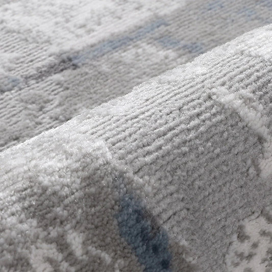 Close-up of textured area rug fabric, showcasing soft fibers and subtle blue-grey pattern for modern interiors #color_gray