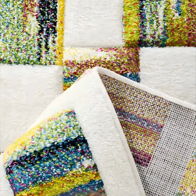 Close-up view of colorful dopamine patchwork rug showing soft texture, backing, and vibrant yarn details