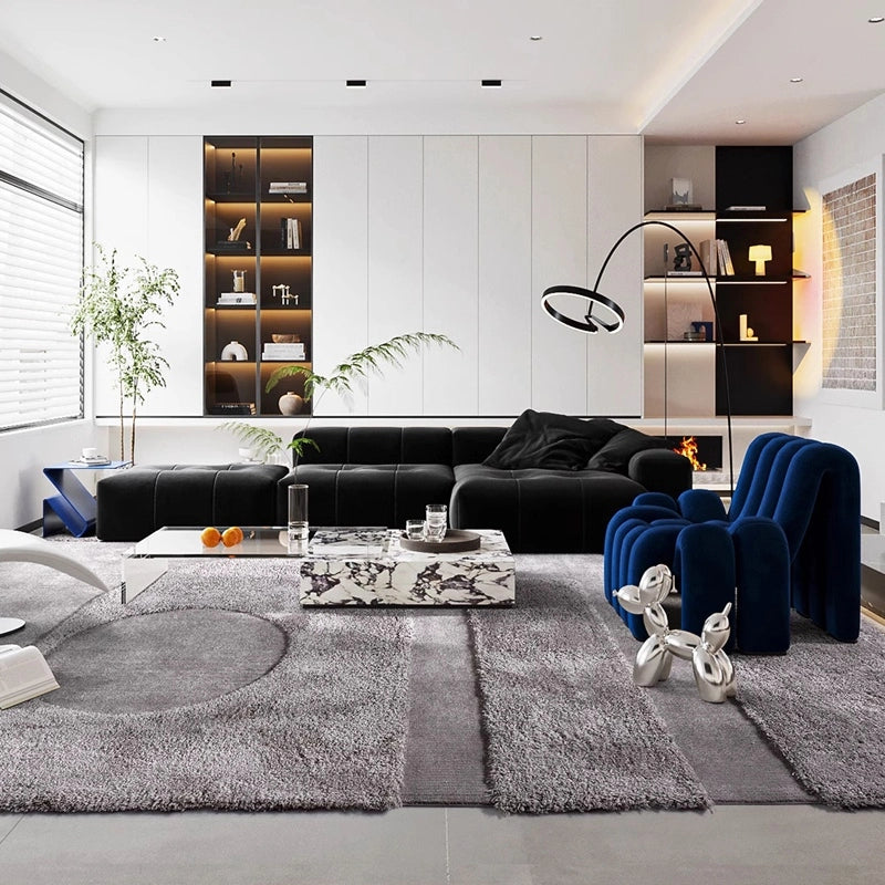 Large gray rug with a blue accent chair and black sectional sofa in a stylish living room #Shape_Rectangle