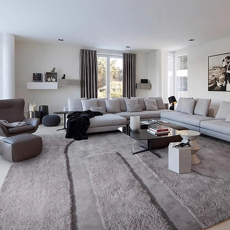 Large gray rug in a modern living room with an L-shaped sofa and minimalist decor #Shape_Rectangle