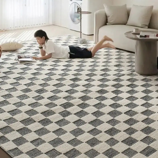 Child lying on a checkered wool rug in a bright living room #color_Black & White Check