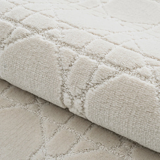 Ivory high-low geometric rug detail showing soft raised texture and thick woven construction