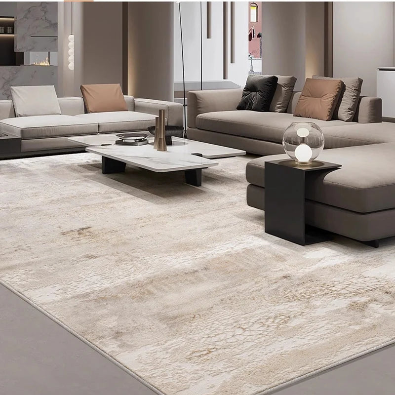 Luxury beige area rug in a modern living room with sleek gray sofas and a marble coffee table