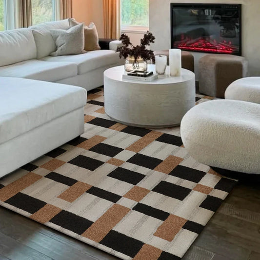 Geometric brown and black checkered rug in a cozy living room with white sectional sofa and fireplace