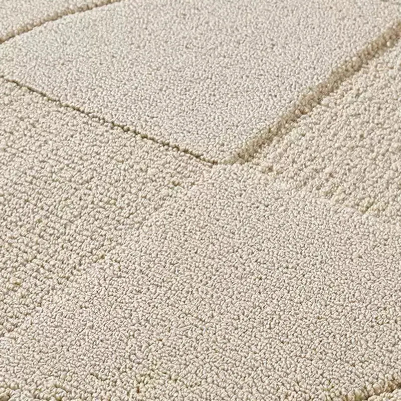 op view of a large geometric rug with 3D circle and square elements in soft cream tones