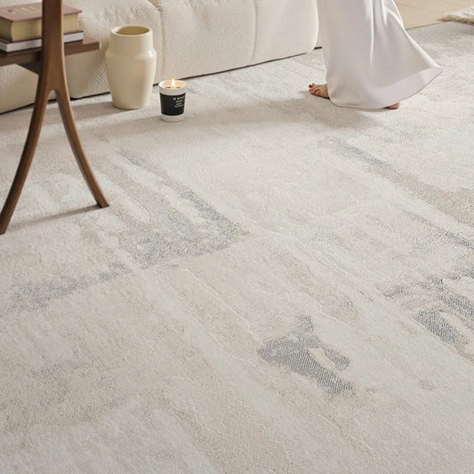 A modern neutral-toned textured rug placed in a cozy living room, paired with minimalist furniture and soft natural lighting, evoking a serene and elegant atmosphere