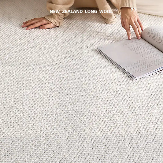 Close-up of a soft New Zealand long wool rug with a person reading on it.