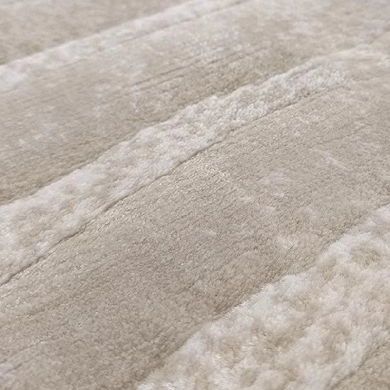 Close-up of plush beige area rug showcasing ultra-soft texture, high-density fibers, and luxurious feel