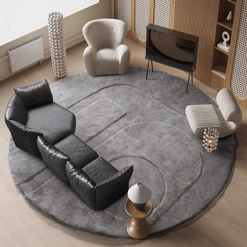 Large round gray rug in a cozy living room with modern black and cream chairs #Shape_Round