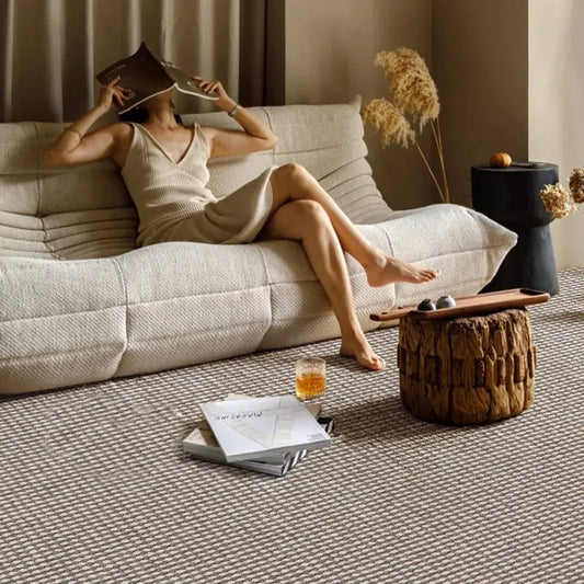 Scandinavian-style sofa paired with minimal wool loop rug for cozy lounging