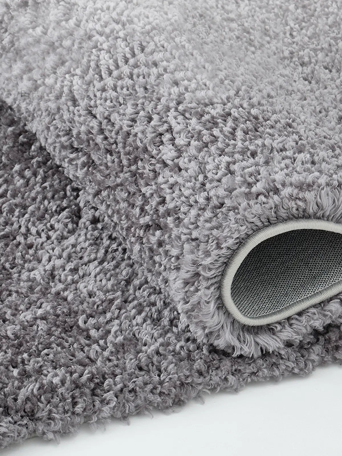 Soft, textured light gray shaggy area rug with plush feel