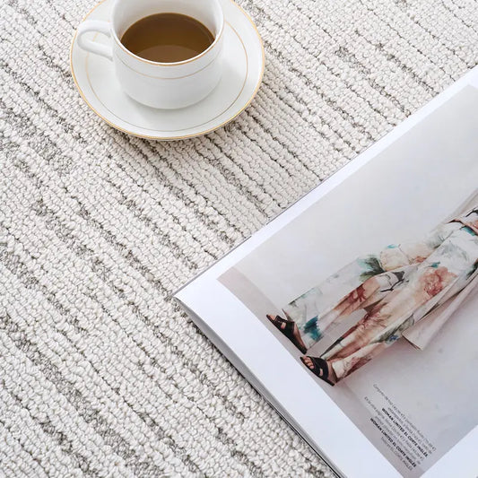 textured neutral rug thick soft stain resistant easy to clean woven close up beige striped with coffee cup