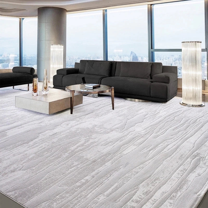 Textured gray rug in a modern living room with a black sofa, glass coffee table, and city skyline view #Texture_Linear Drift