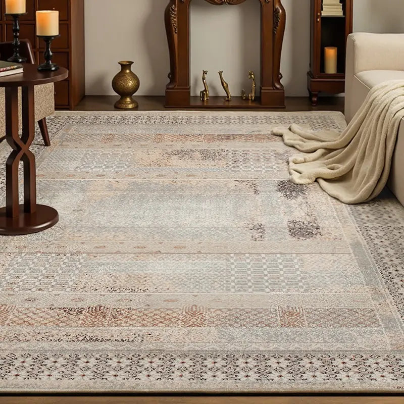 Vintage patterned area rug in a traditional living room setting with warm lighting and wooden furniture