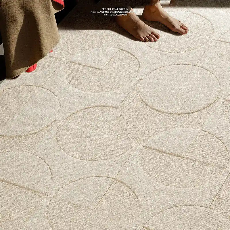 Close-up of cream 3D geometric rug with embossed circles and arcs, made from diatom fiber with waterproof texture