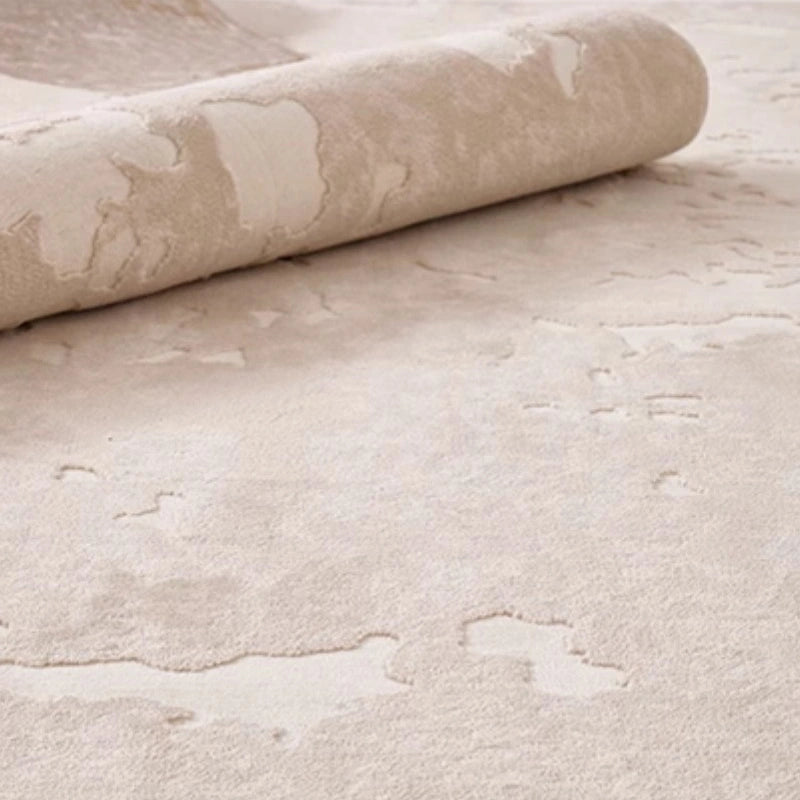 Beige abstract rug partially rolled up, showcasing plush texture and artistic design with soft raised patterns #Texture_Mist