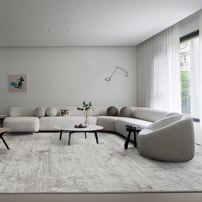 Elegant living room with a neutral-toned abstract rug, minimalist furniture, and soft natural light #color_gray