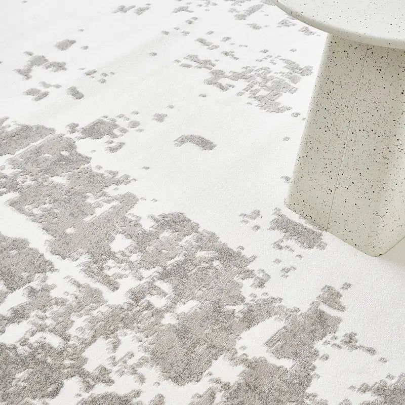 Close-up view of abstract pattern rug showcasing textured details and soft neutral tones #color_white