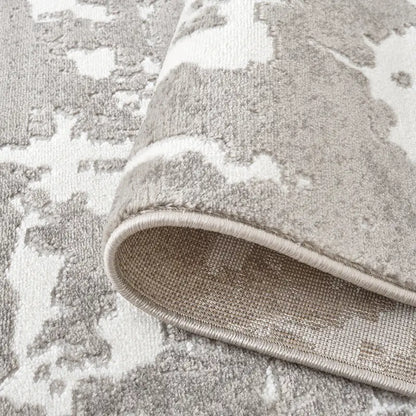 Detailed close-up of the abstract rug's edge showcasing durable stitching and high-quality texture #color_white