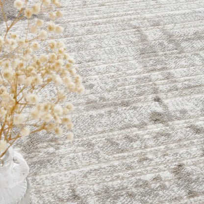 Close-up of an abstract rug with decorative dry flowers in a glass vase #color_gray