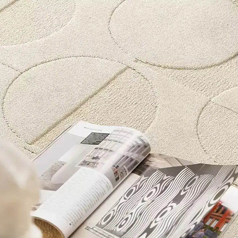 Close-up of a beige rug featuring 3D embossed geometric circle pattern with high-low texture