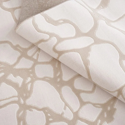 Close-up of a beige abstract rug showcasing intricate patterns and soft texture #Texture_Vein