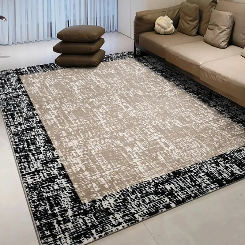 Beige area rug with a bold black border, adding depth and contrast to a cozy living space featuring tan cushions #color_beige