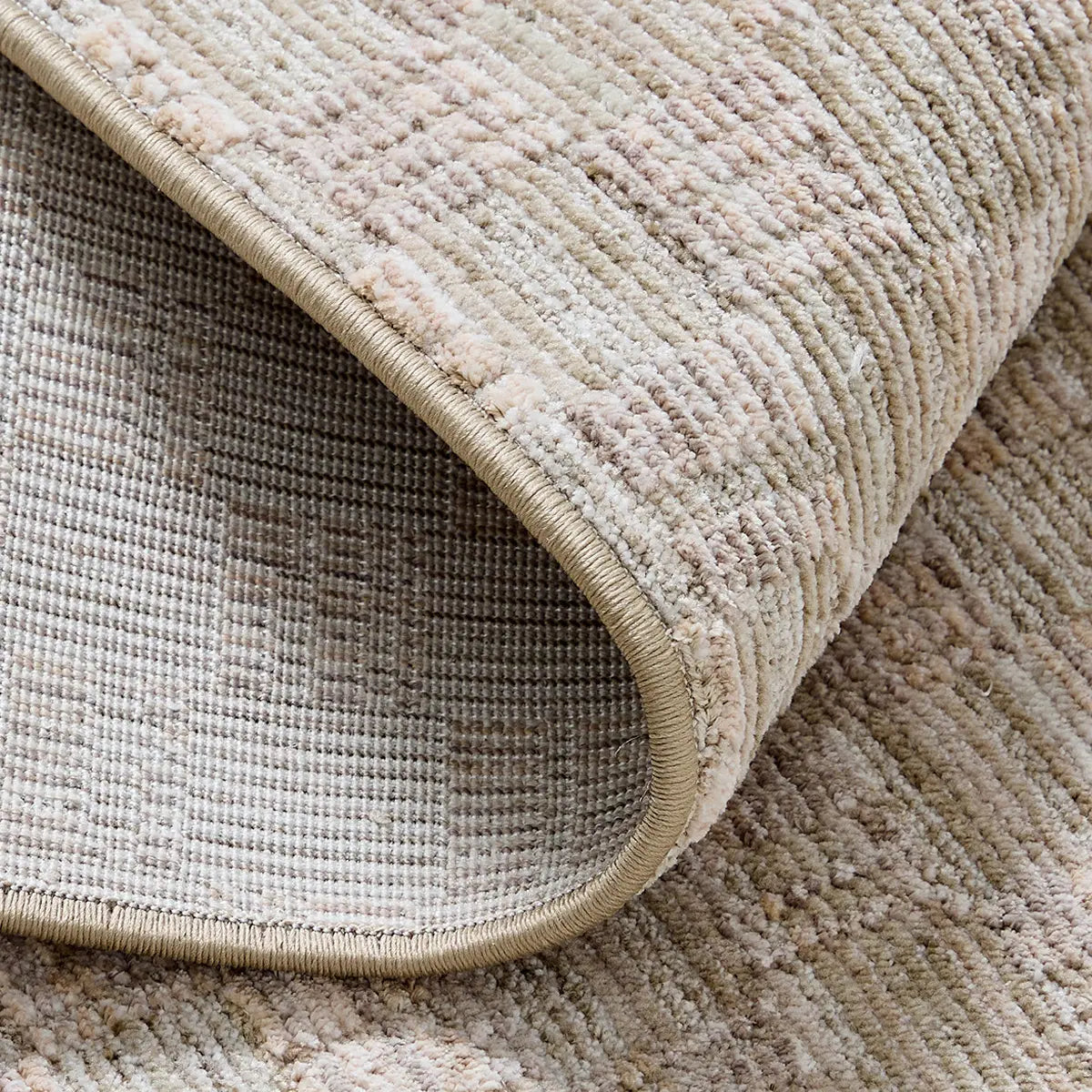 Beige crosshatch woven rug backing with finished edge and textured surface detail