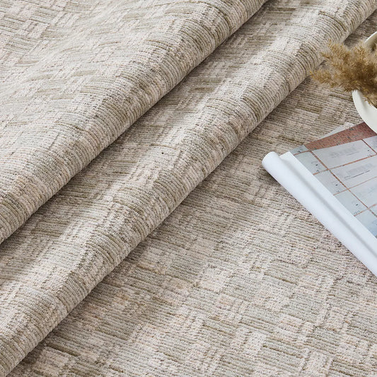 Close-up of a beige crosshatch woven rug showing raised texture and soft neutral tones
