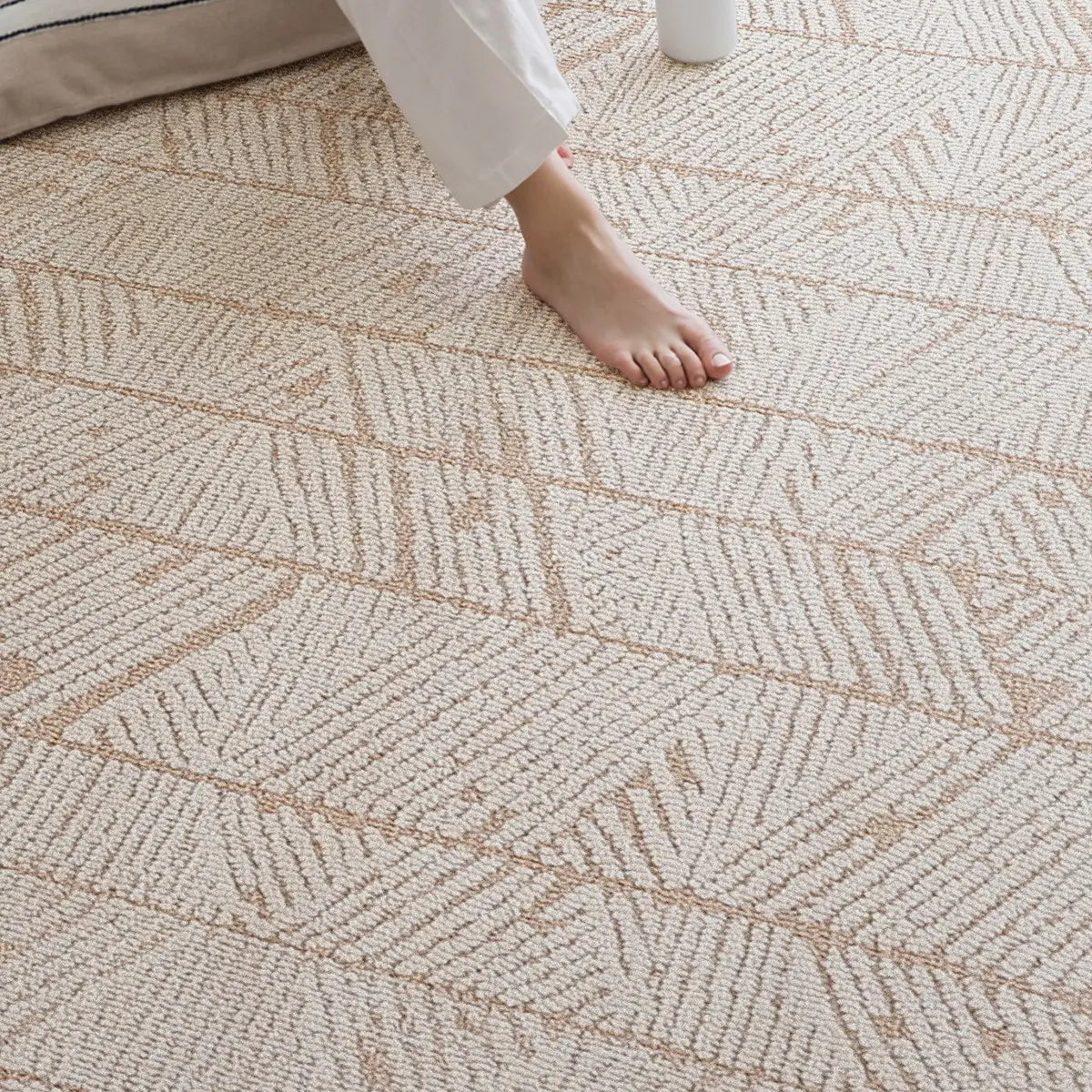 Beige geometric leaf rug with a dense loop surface shown underfoot for a stable everyday feel