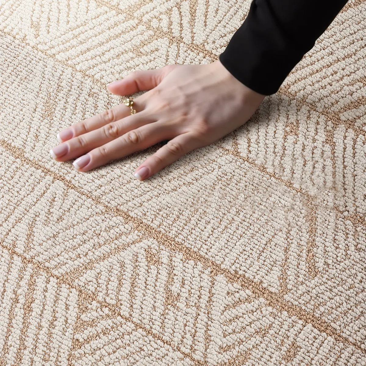 Close-up of a beige geometric leaf rug with a raised high-low loop texture and dense woven construction