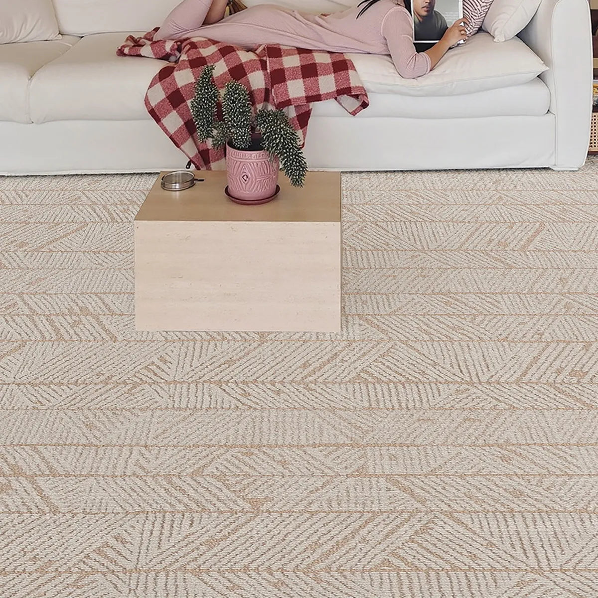 Beige geometric leaf area rug with a dense woven surface and raised loop texture in a modern living room