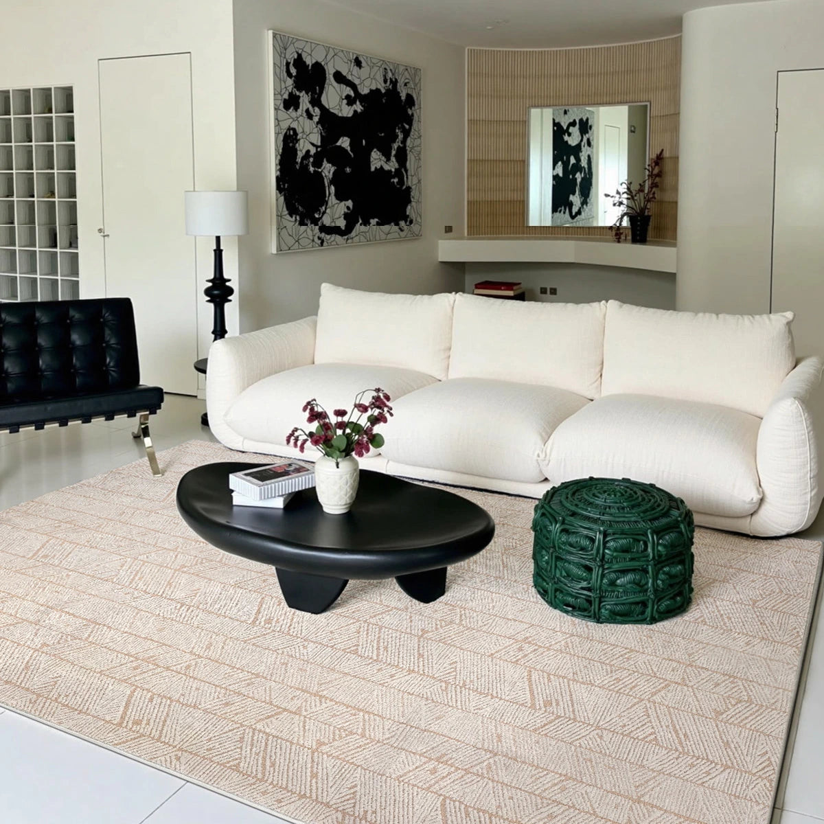 Beige geometric leaf area rug styled beneath a sofa in a warm neutral living room