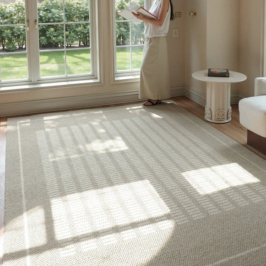 Beige minimalist area rug in a bright modern room with a soft woven texture