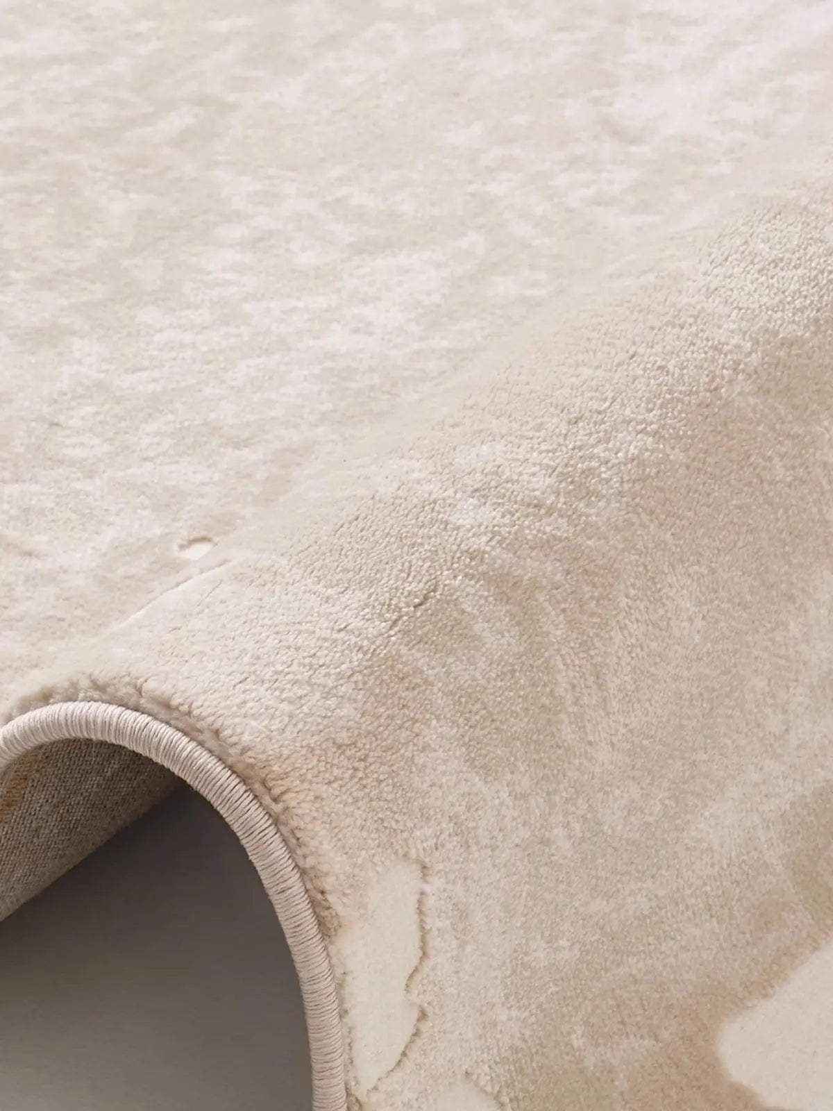 Beige modern rug with soft plush pile, showcasing the detailed texture and durable binding for a luxurious feel