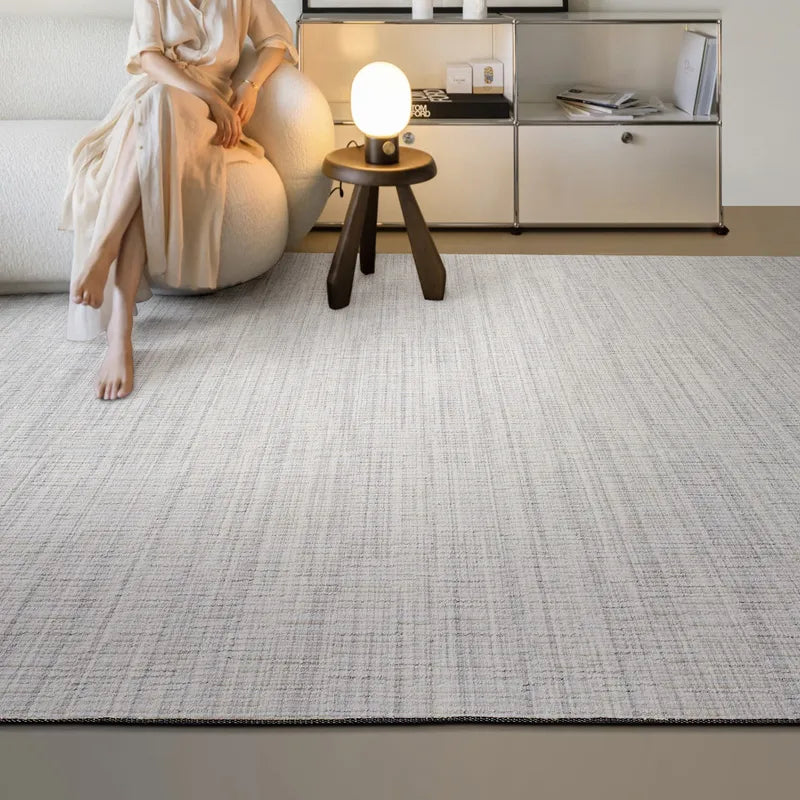 Minimalist living space featuring beige wool blend rug with natural textured pattern and warm, serene ambiance