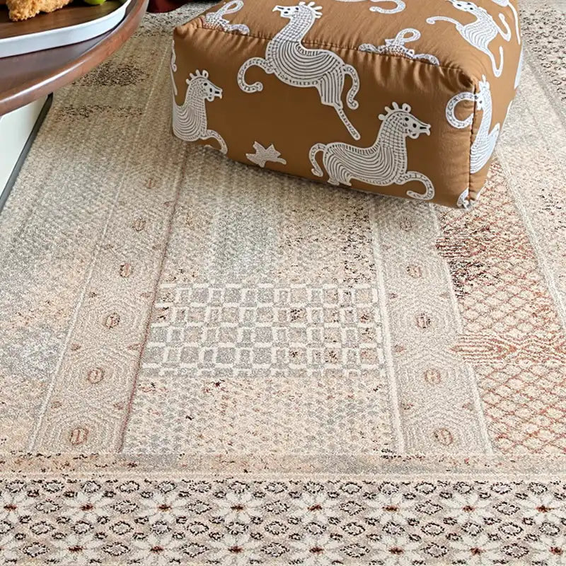 Close-up of beige vintage-style rug showing intricate texture and pattern details