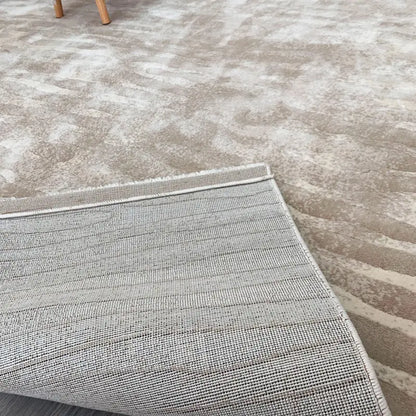 Close-up of beige wave-pattern area rug showcasing durable jute backing, reinforced edges, and high-quality craftsmanship