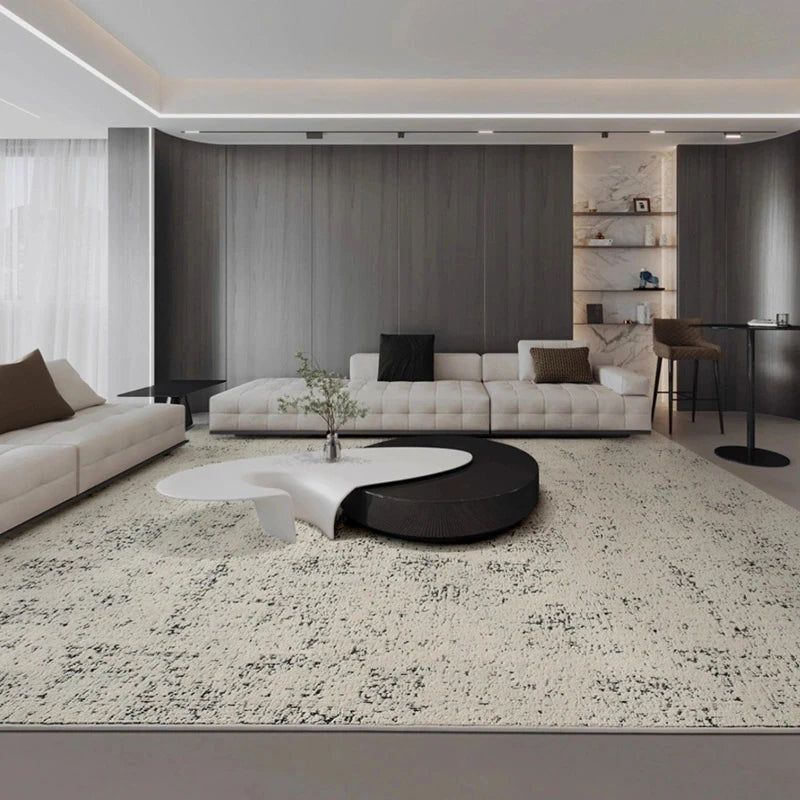 beige and black modern area rug with distressed pattern in a minimalist living room
