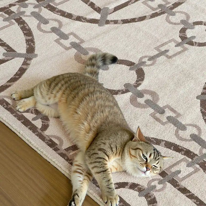 Tabby cat relaxing on a cream-colored rug with geometric chain design