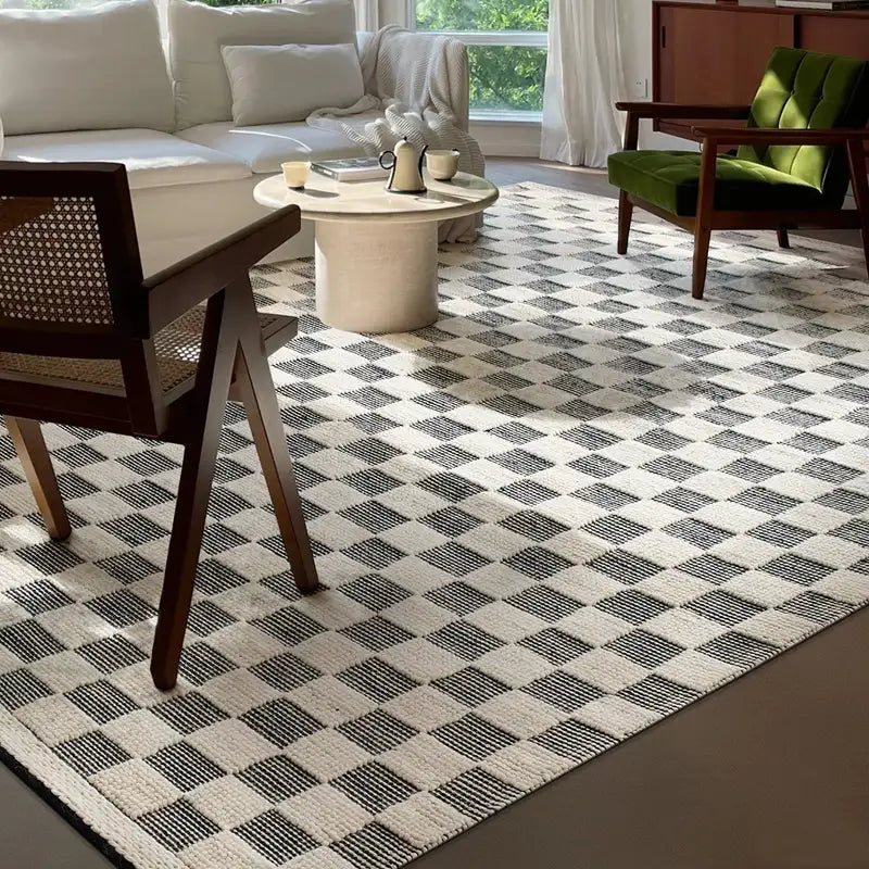 Modern living room featuring a black and white checkered wool rug, complementing a cozy seating area and natural light #color_Black & White Check