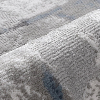 Close-up of textured area rug fabric, showcasing soft fibers and subtle blue-grey pattern for modern interiors #color_gray