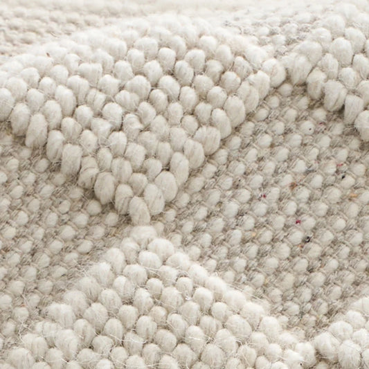 wool living room rug close up thick handwoven texture natural fiber breathable soft durable weave pattern detail