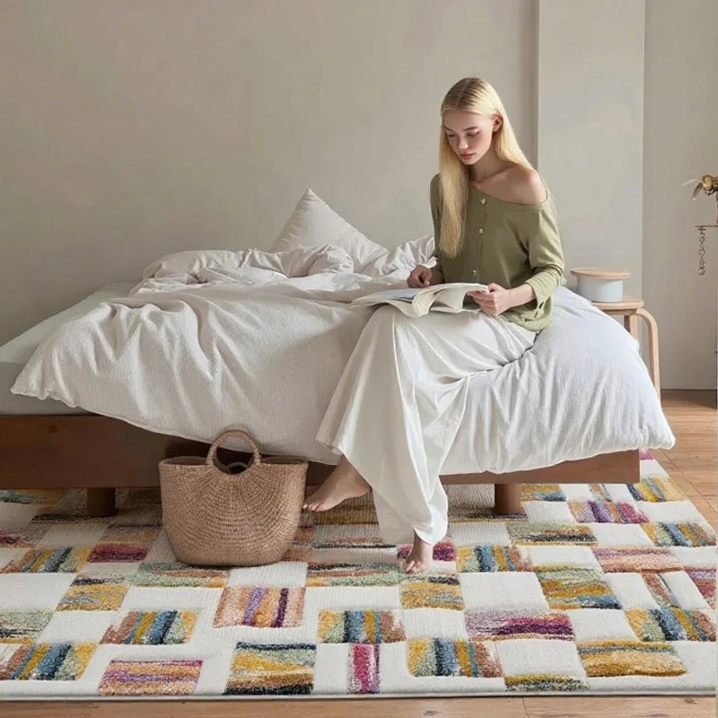 Cozy bedroom scene with a colorful rug and a woman reading on a white bed, soft morning light